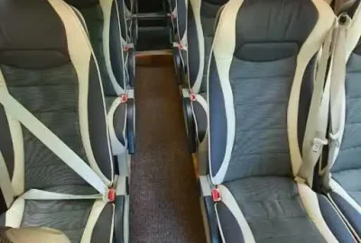 Interior of a premium tourist bus with ergonomic seats and ample space.