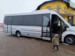 Side view of a tourist bus, showcasing modern design and comfort.