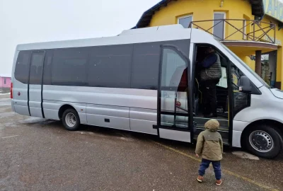 Side view of a tourist bus, showcasing modern design and comfort.