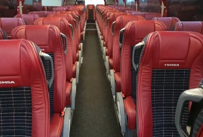 Vue intérieure d'un autocar Temsa avec des sièges rouges modernes et confortables.