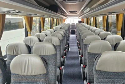 Interior view of a VanHool bus showing comfortable seating arrangement and spacious design.