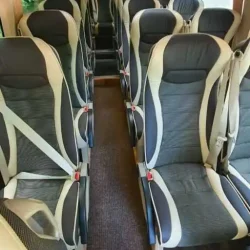 Interior of a premium tourist bus with ergonomic seats and ample space.