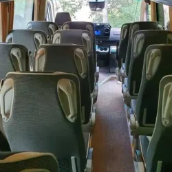 Rear view of a premium tourist bus interior, showcasing modern features and comfort.