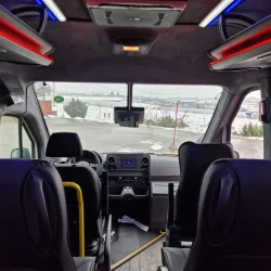 Interior view of the driver's area in a premium tourist bus with a scenic snowy backdrop.