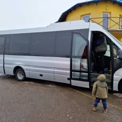 Side view of a tourist bus, showcasing modern design and comfort.